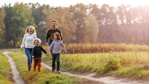 Familie mit zwei Kindern auf einem Spaziergang in der Natur